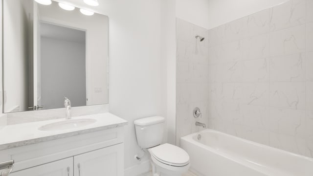 full bathroom with tiled shower / bath combo, toilet, and vanity