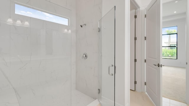 bathroom featuring a shower with shower door