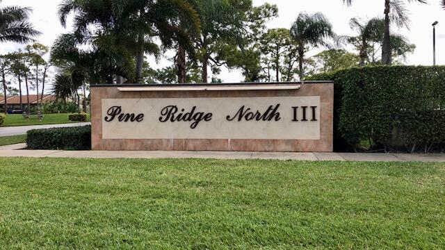 community / neighborhood sign with a lawn