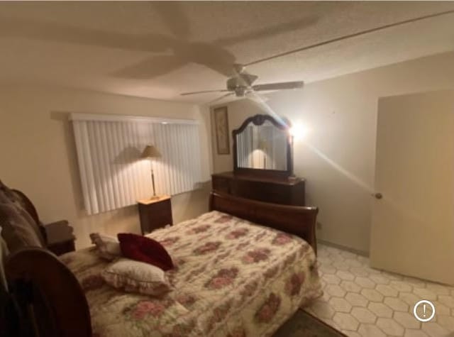 bedroom with tile patterned flooring and ceiling fan