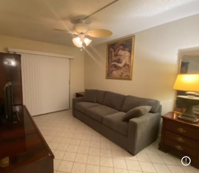 tiled living room featuring ceiling fan