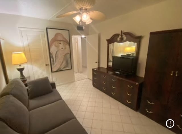 living room with ceiling fan and tile patterned flooring