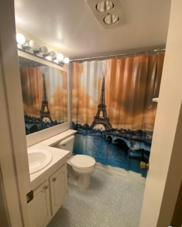 bathroom featuring vanity, toilet, and tile patterned floors