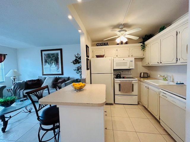 kitchen with white cabinetry, sink, a kitchen breakfast bar, white appliances, and light tile patterned floors