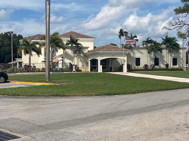 view of front of house with a front yard and a carport