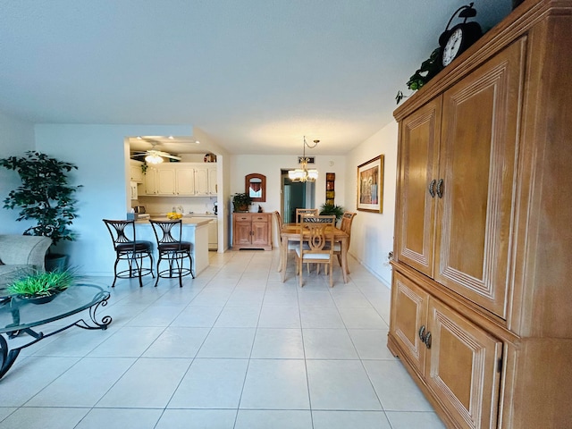 dining room featuring ceiling fan with notable chandelier and light tile patterned flooring