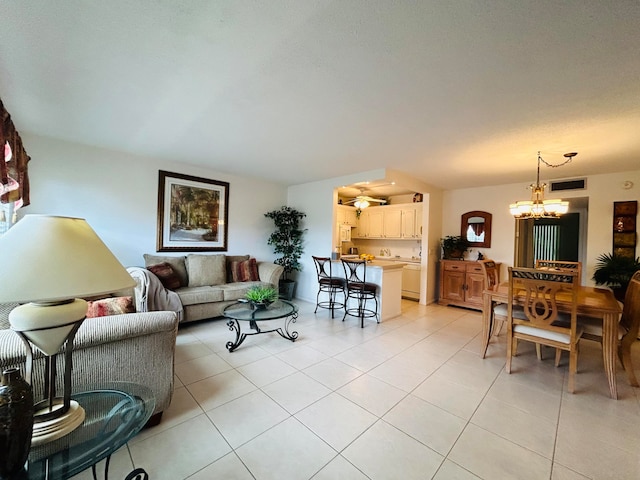 living room with a notable chandelier and light tile patterned flooring