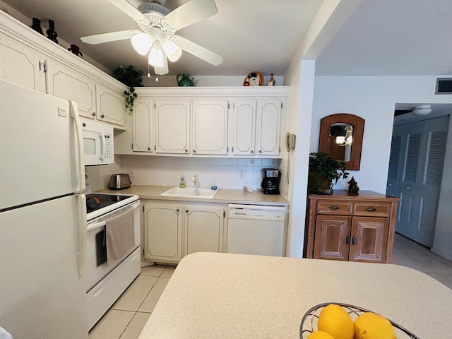 kitchen featuring ceiling fan, sink, tasteful backsplash, white appliances, and light tile patterned floors