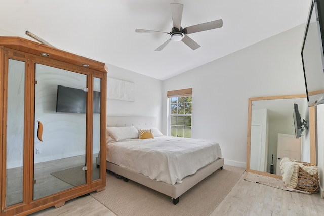 bedroom with vaulted ceiling, light wood-type flooring, and ceiling fan