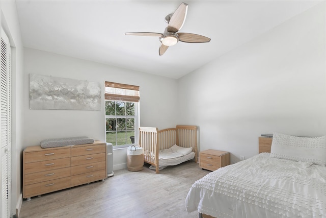 bedroom featuring light hardwood / wood-style flooring, a closet, and ceiling fan