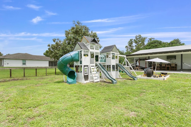 view of play area with a patio area and a lawn