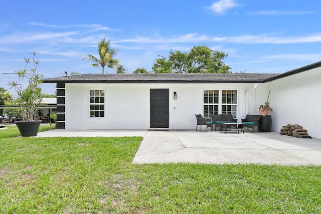 rear view of house with a yard and a patio area