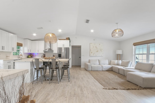 living room with lofted ceiling and light hardwood / wood-style floors