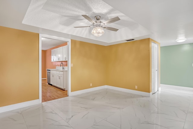 empty room featuring ceiling fan and sink