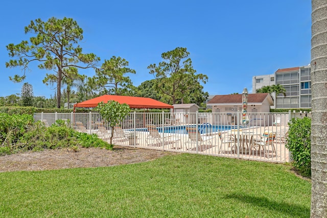 view of swimming pool with a yard and a patio