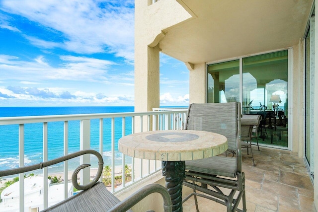 entrance foyer with a tray ceiling and a water view