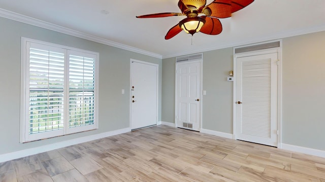 spare room with baseboards, ornamental molding, and light wood-style flooring