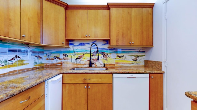 kitchen with a sink, light stone countertops, brown cabinets, and dishwasher