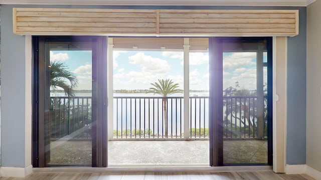 doorway to outside featuring wood finished floors and baseboards