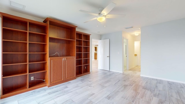 unfurnished living room with ceiling fan, visible vents, and baseboards