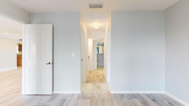 interior space with light wood-type flooring, baseboards, and visible vents