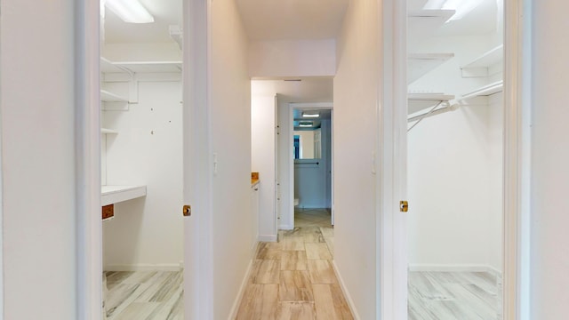 interior space with baseboards and wood finish floors