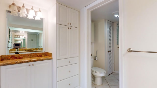 bathroom featuring tile patterned flooring, a closet, and toilet