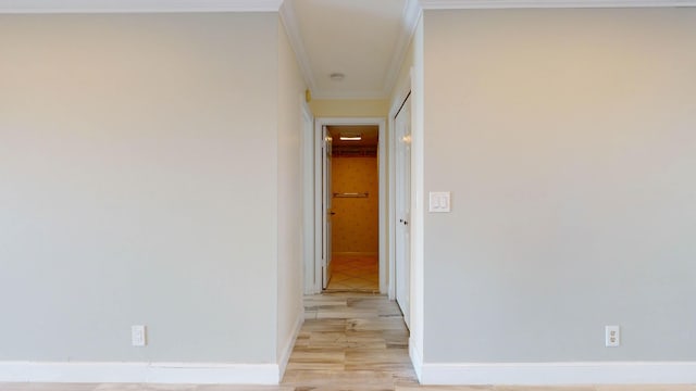 hall with light wood finished floors and baseboards