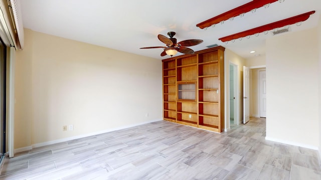 unfurnished room with visible vents, ceiling fan, and baseboards