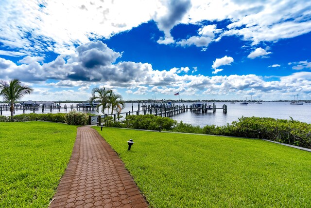 624 SW Saint Lucie Cres Unit 302, Stuart, FL 34994 - view of dock with a water view and a lawn