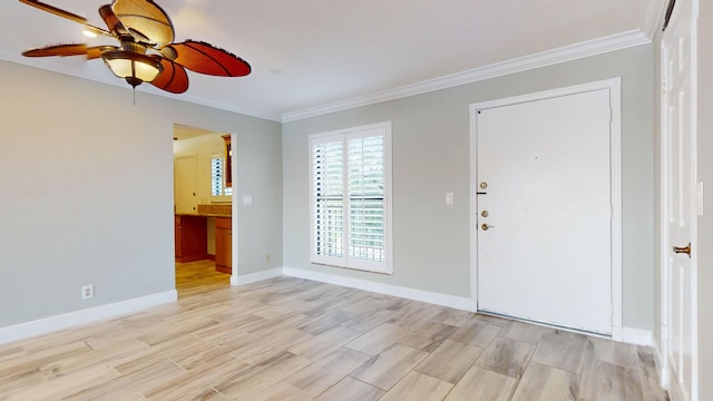 entryway featuring light wood-style floors, crown molding, baseboards, and a ceiling fan