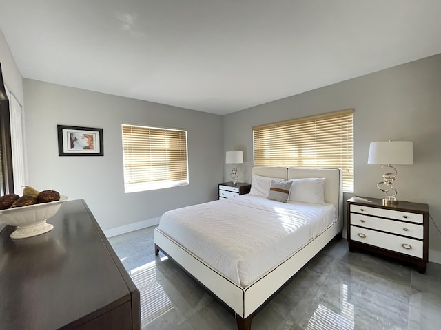 bedroom featuring multiple windows and baseboards