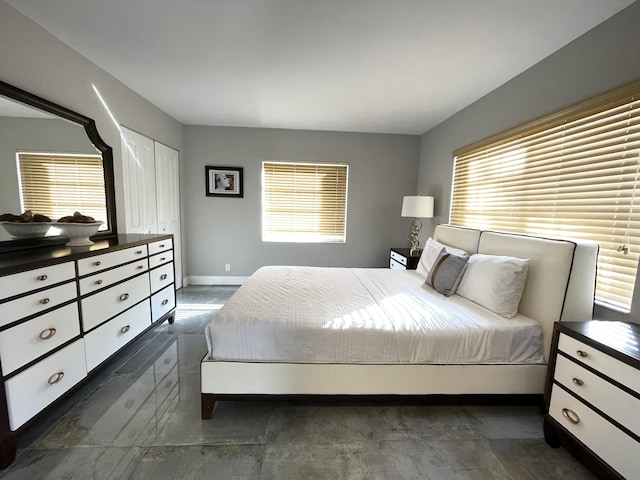 bedroom featuring multiple windows and baseboards