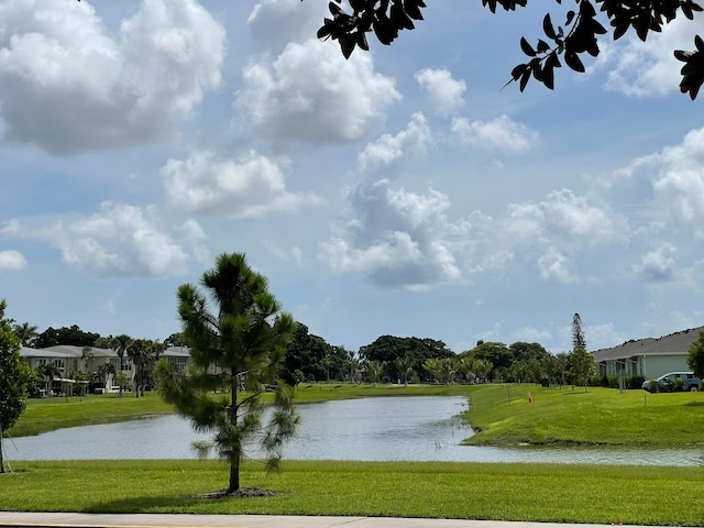 rear view of property with a yard and a water view