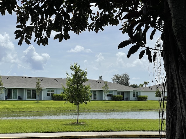 ranch-style home with a water view and a front yard