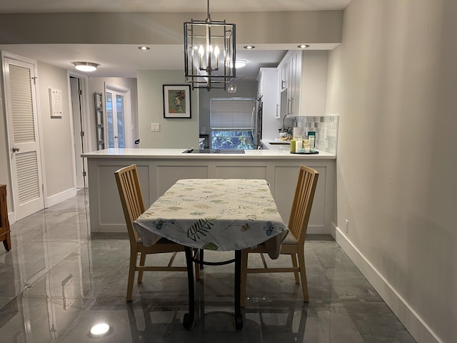 dining room with baseboards, a chandelier, marble finish flooring, and recessed lighting