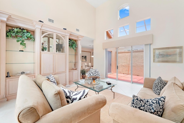 tiled living room with built in shelves and a towering ceiling