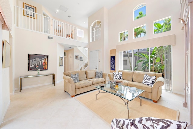 tiled living room with a high ceiling