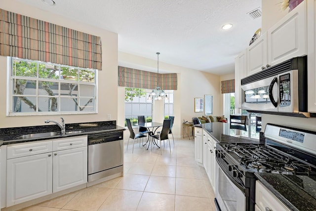 kitchen with plenty of natural light, white cabinetry, and stainless steel appliances