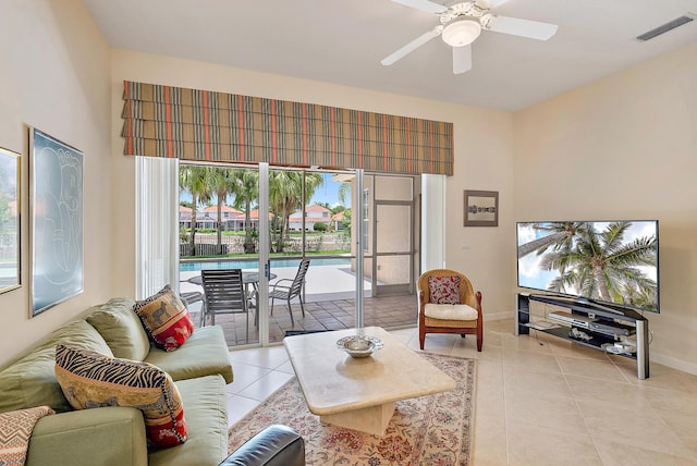 tiled living room with ceiling fan