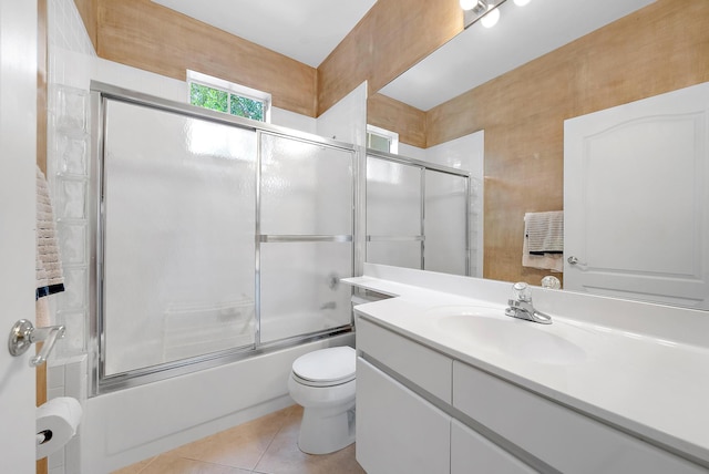 full bathroom featuring tile patterned floors, vanity, enclosed tub / shower combo, and toilet