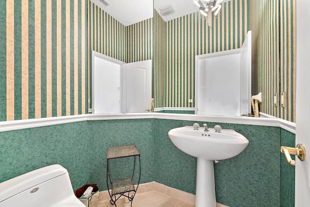 bathroom with toilet, tile patterned flooring, and ceiling fan