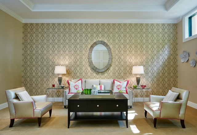 living area with ornamental molding and a tray ceiling