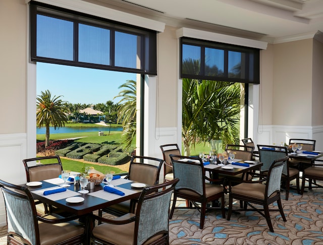 dining space with ornamental molding and a wealth of natural light