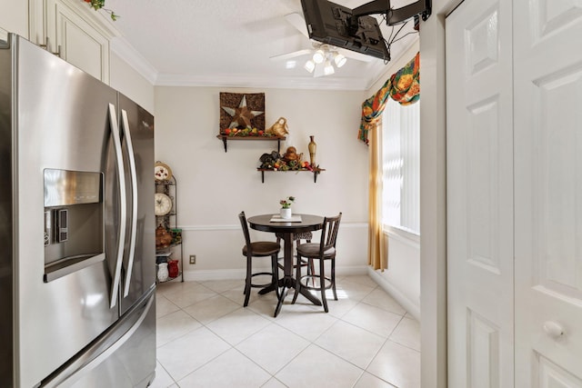 dining space featuring crown molding, ceiling fan, a textured ceiling, and light tile patterned floors