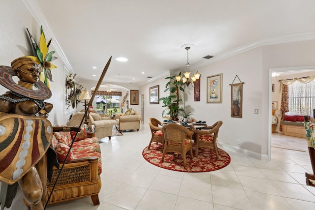 dining area featuring an inviting chandelier, ornamental molding, and light tile patterned flooring