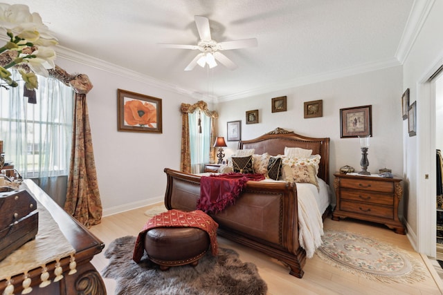 bedroom featuring light hardwood / wood-style flooring, ornamental molding, and ceiling fan