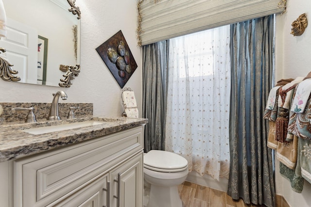 full bathroom featuring vanity, toilet, wood-type flooring, and shower / bath combo