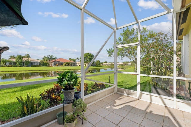 unfurnished sunroom featuring plenty of natural light and a water view