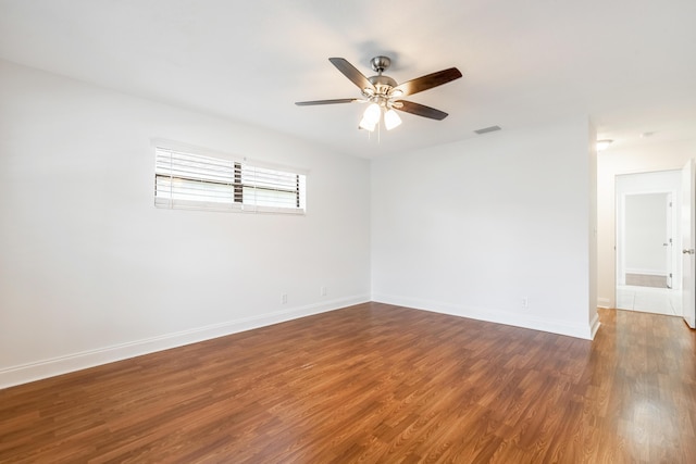 empty room featuring dark hardwood / wood-style flooring and ceiling fan